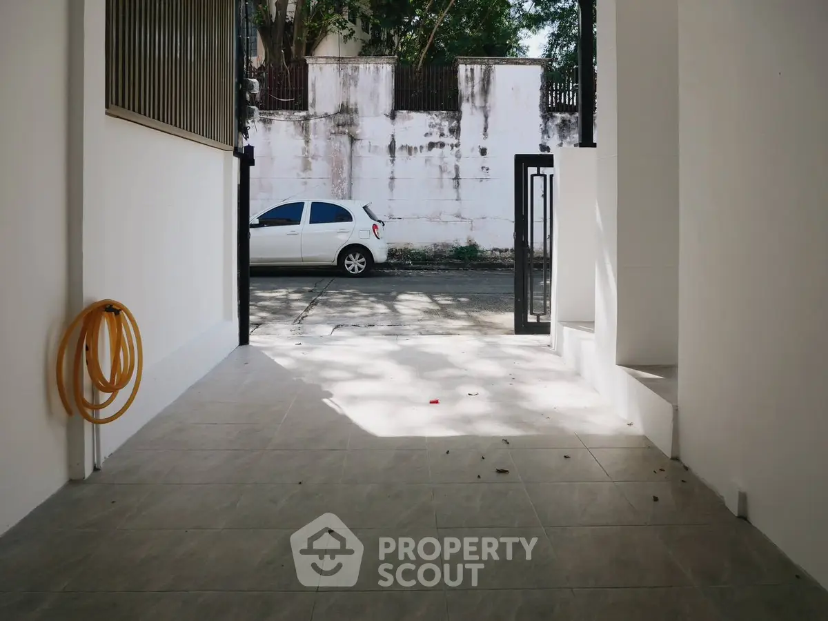Spacious open garage with tiled flooring and street view
