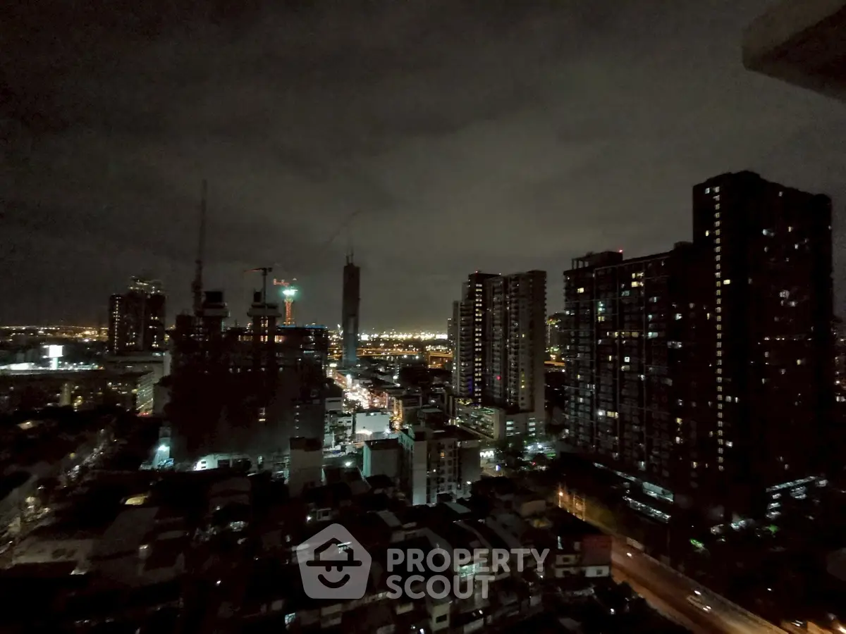 Stunning cityscape view from high-rise building at night, showcasing urban skyline and vibrant city lights.