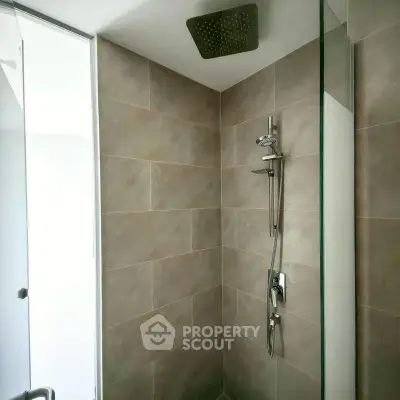 Modern bathroom with sleek shower design and neutral tiles