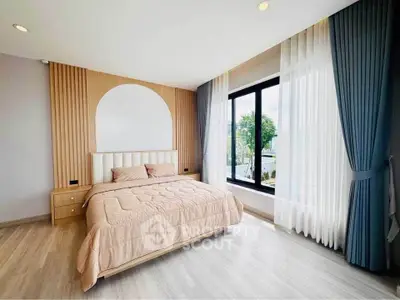 Spacious modern bedroom with large window and elegant decor