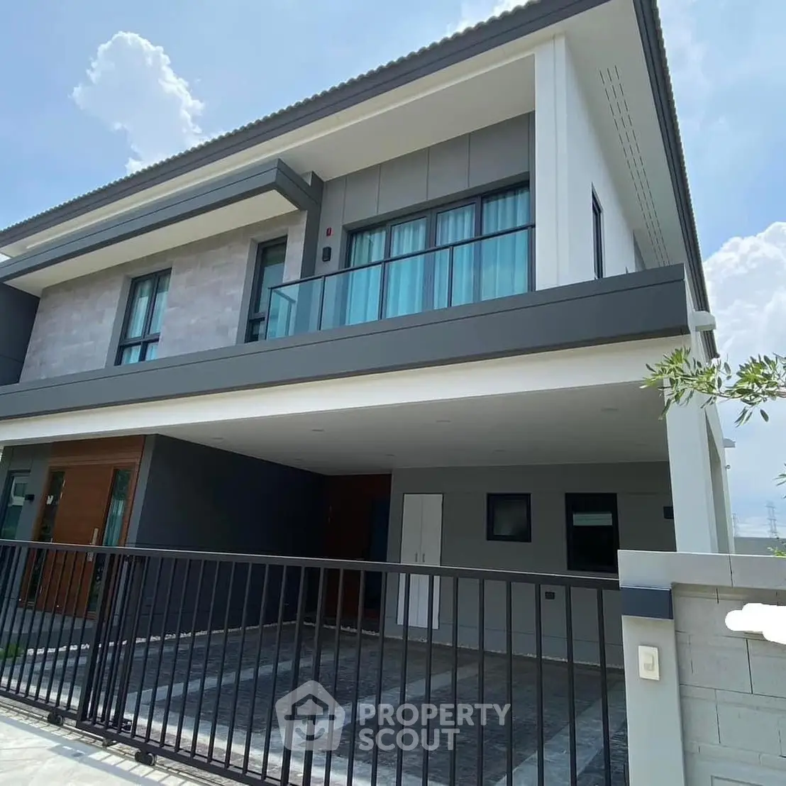 Modern two-story house with sleek design and spacious carport
