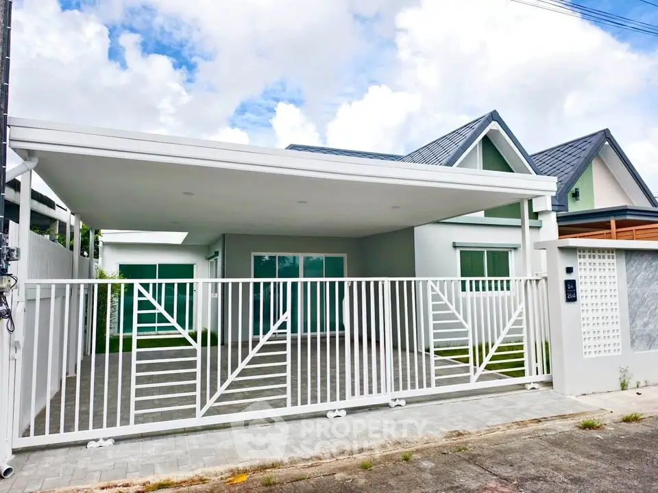 Modern single-story house with spacious carport and stylish gate