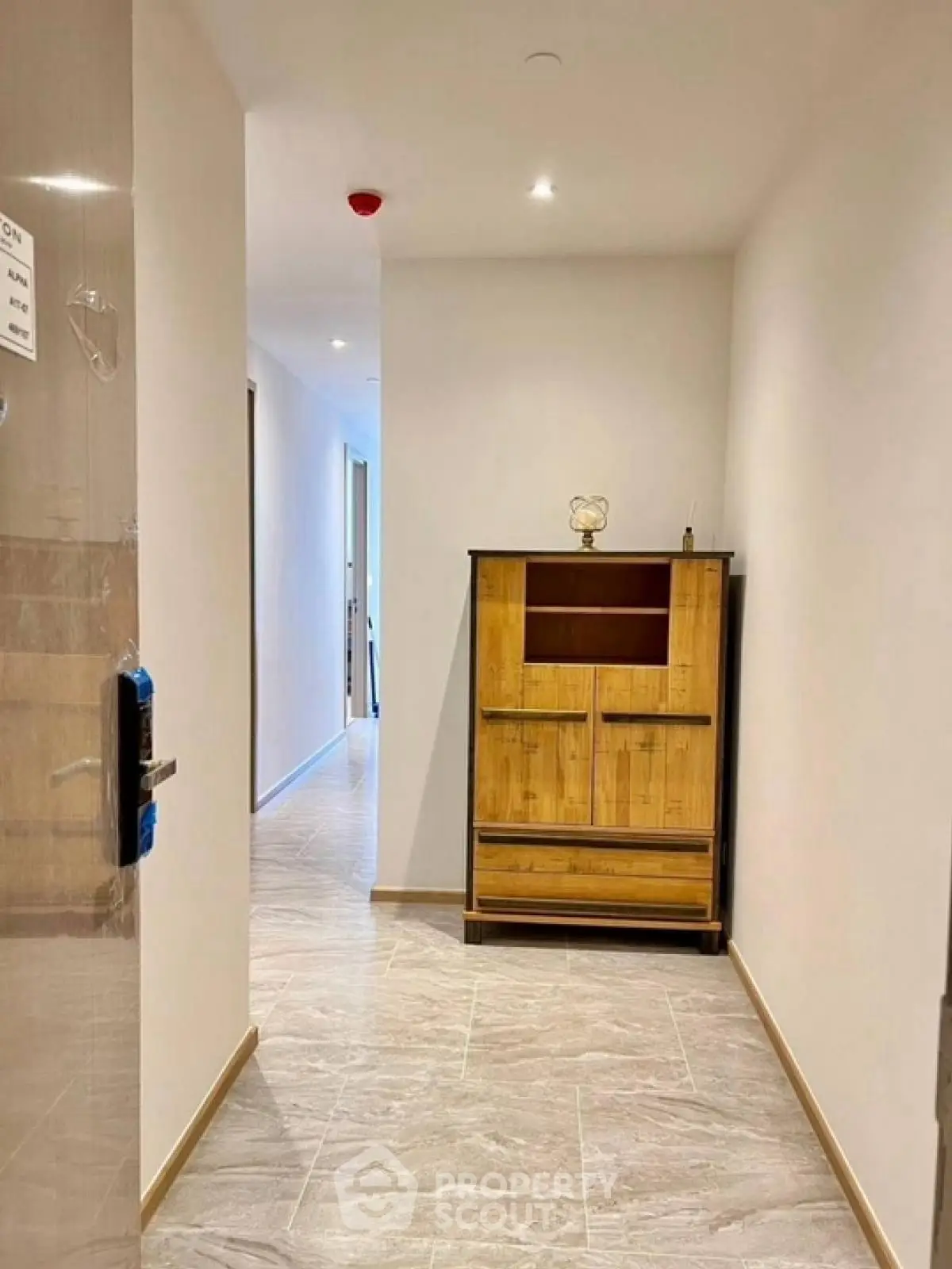 Modern hallway with stylish wooden cabinet and sleek tile flooring