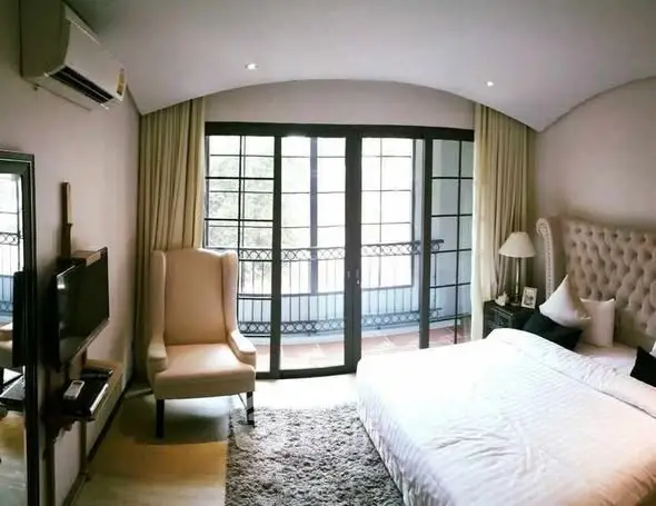 Luxurious bedroom with elegant decor and large windows for natural light