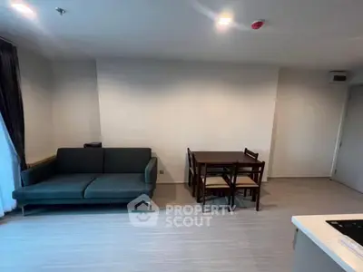 Modern living room with sleek sofa and dining set in open layout
