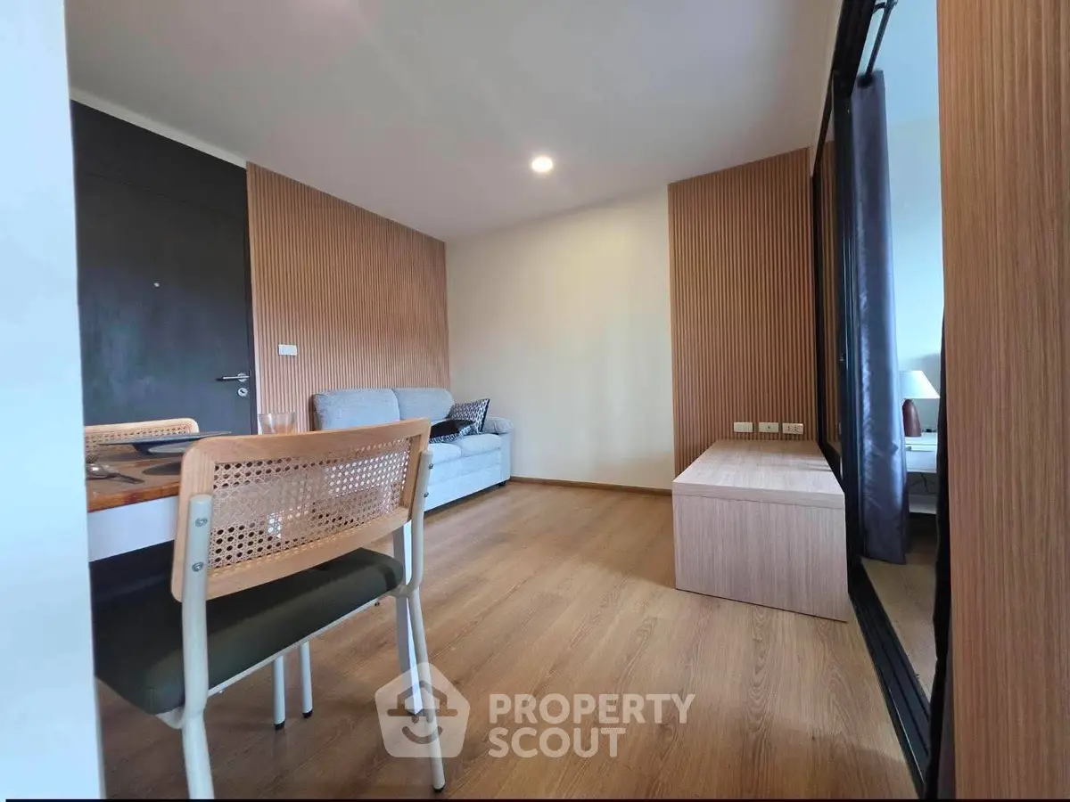 Modern living room with wooden flooring and stylish furniture in a cozy apartment.