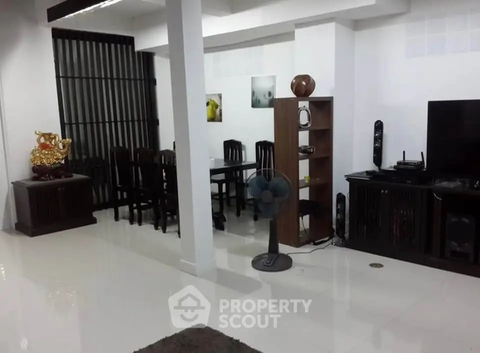 Spacious living room with modern decor and dining area