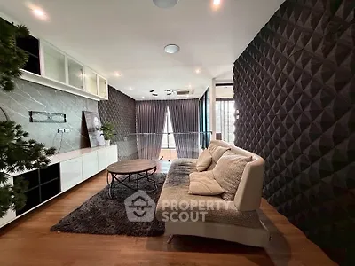 Stylish modern living room with textured walls and cozy seating area.