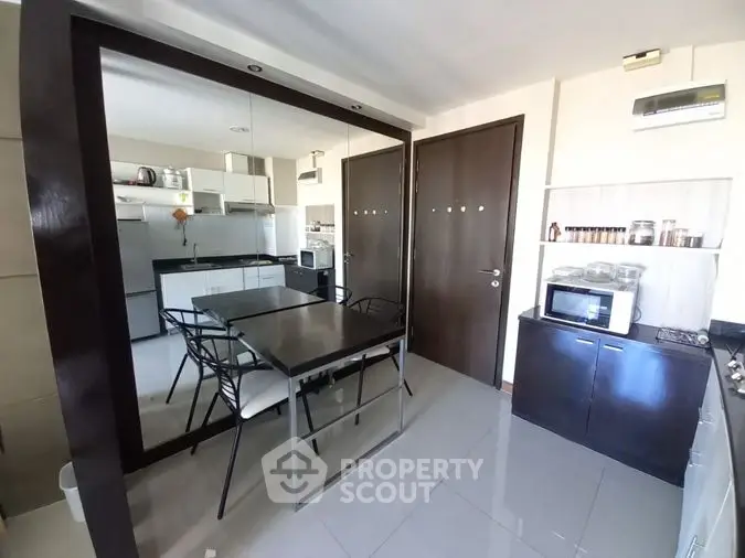 Modern kitchen with sleek design, featuring stainless steel appliances, glossy countertops, and ample storage space, perfect for culinary enthusiasts.