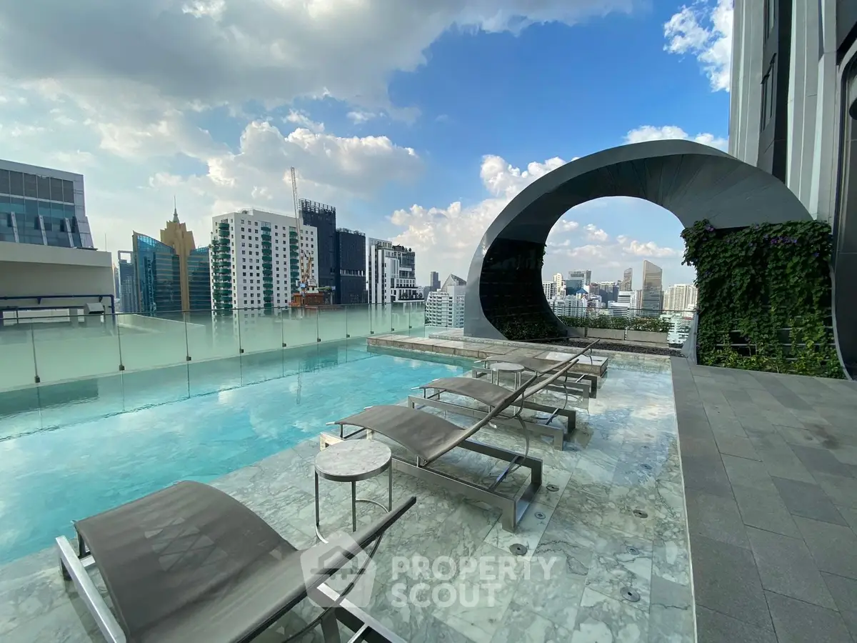 Luxurious rooftop pool with stunning city views and modern lounge chairs.
