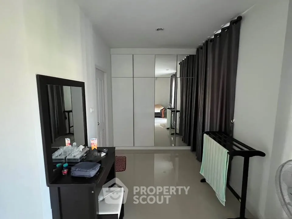 Spacious bedroom with sleek wardrobe and modern decor