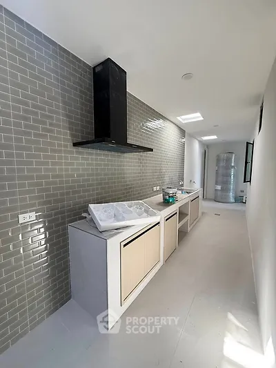 Modern kitchen with sleek design, featuring a gas stove and ample counter space, perfect for culinary enthusiasts.