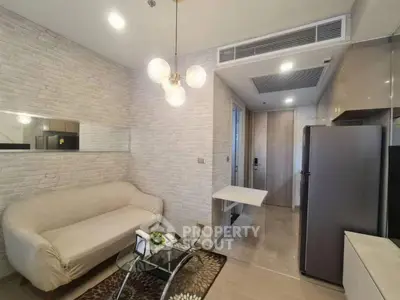 Modern living room with stylish sofa and open kitchen layout in a contemporary apartment.