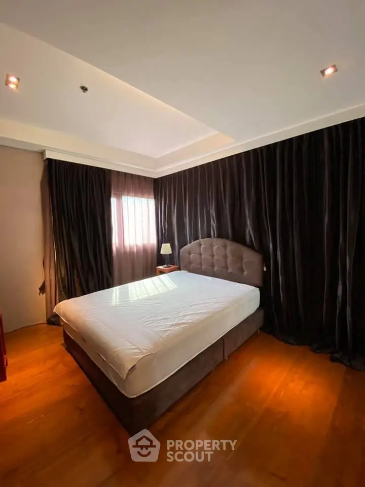 Luxurious bedroom with elegant dark curtains and cozy lighting