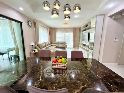 Luxurious open-plan living room with elegant dining area and modern decor
