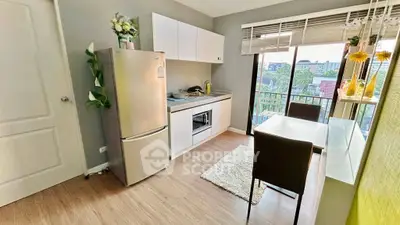 Modern kitchen with balcony view, featuring sleek appliances and stylish decor.