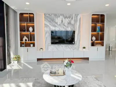 Luxurious modern living room with marble accent wall and built-in shelving