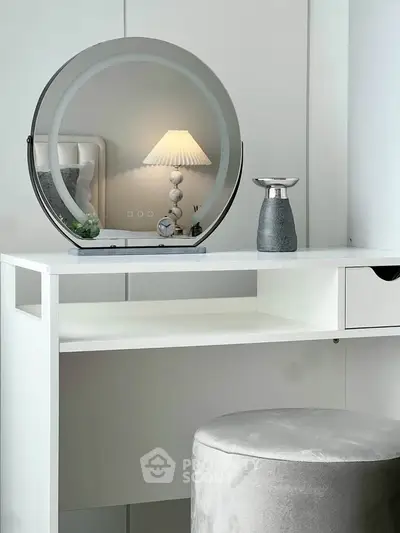 Elegant bedroom vanity with round mirror and modern decor