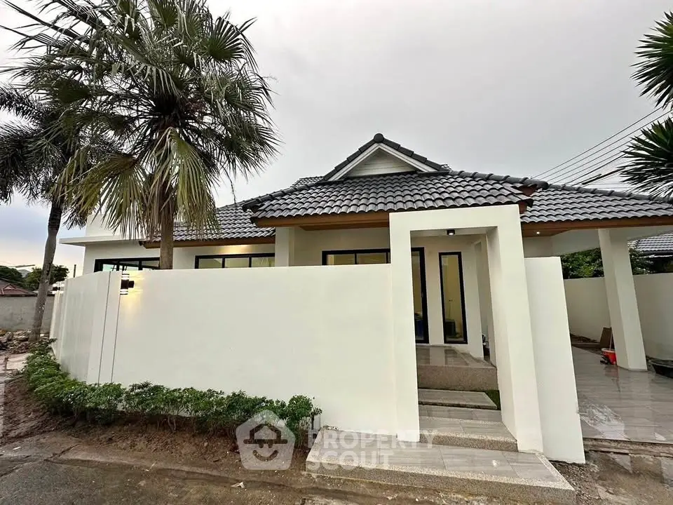 Charming single-story home with modern design and lush landscaping