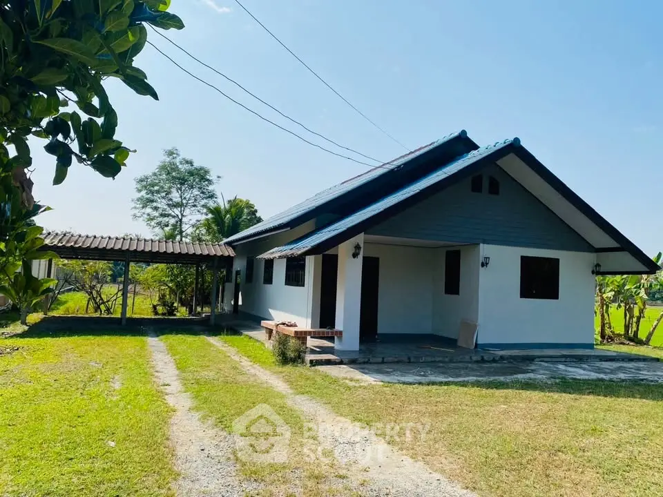 Charming countryside house with spacious garden and covered driveway, perfect for serene living.