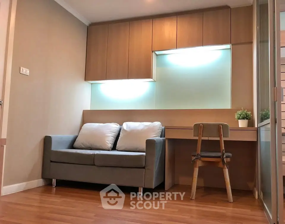 Modern living room with cozy sofa and stylish wooden desk, perfect for urban living.