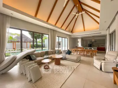 Luxurious open-plan living room with high ceilings and pool view, perfect for modern living.