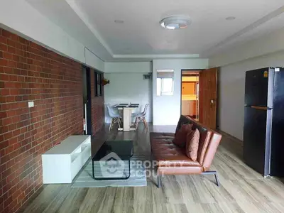 Spacious modern living room with brick accent wall and stylish furniture