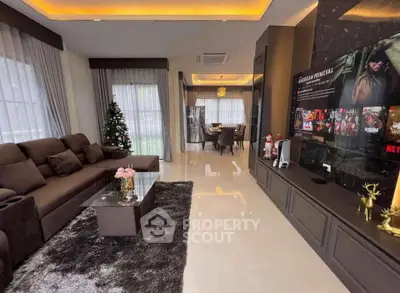 Luxurious living room with modern decor and entertainment setup, perfect for family gatherings.