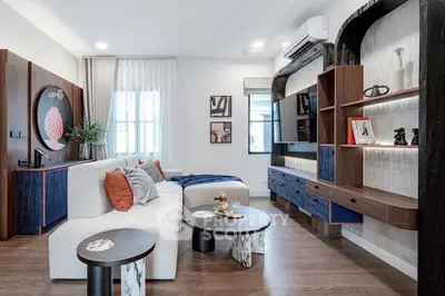Modern living room with stylish decor and contemporary furniture, featuring a cozy ambiance and elegant design.