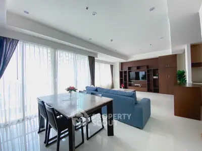 Spacious modern living room with large windows and elegant furniture