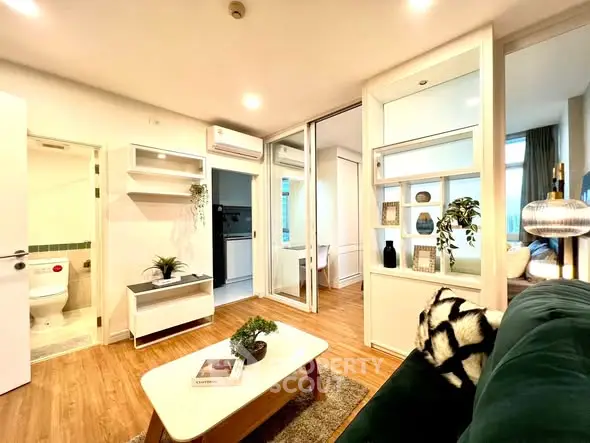 Modern living room with stylish decor and open layout, featuring wooden flooring and cozy ambiance.