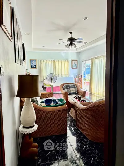 Cozy living room with wicker furniture and natural light, perfect for relaxation.