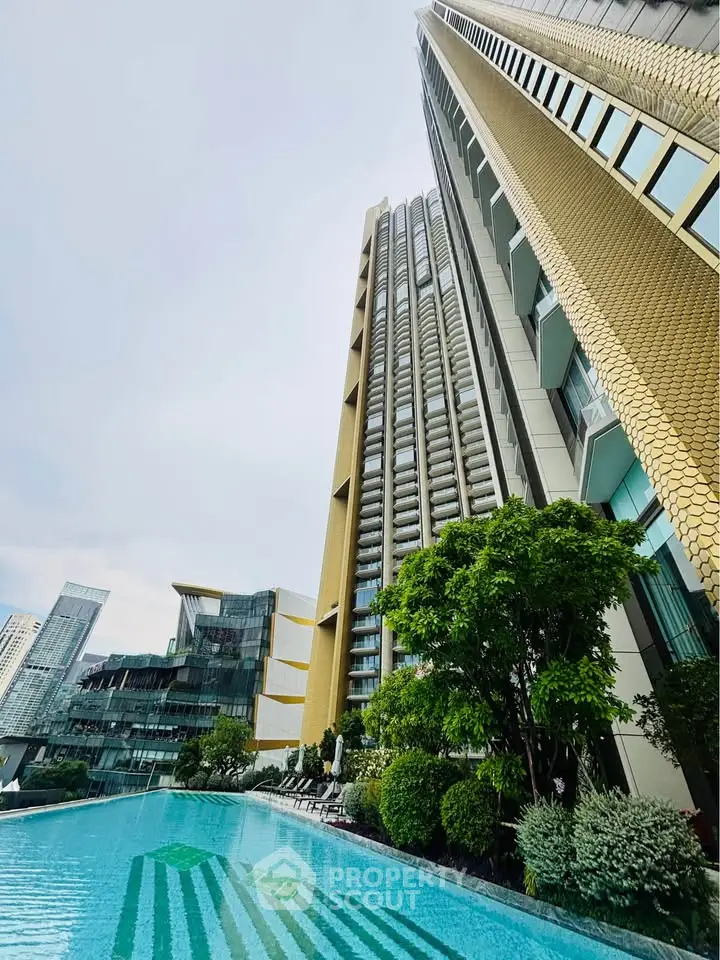 Luxurious high-rise building with stunning pool and lush greenery, offering modern urban living in prime location.