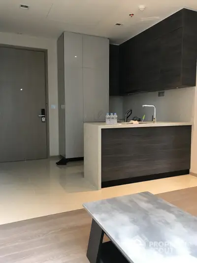 Modern kitchen with sleek cabinetry and minimalist design in a contemporary apartment.