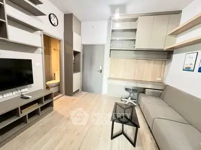 Modern living room with sleek furniture and wall-mounted TV