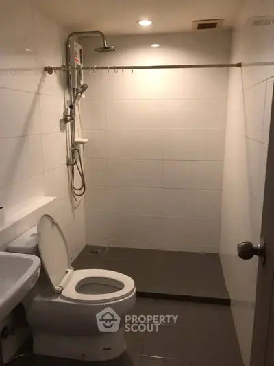 Modern bathroom with sleek shower and white tiles