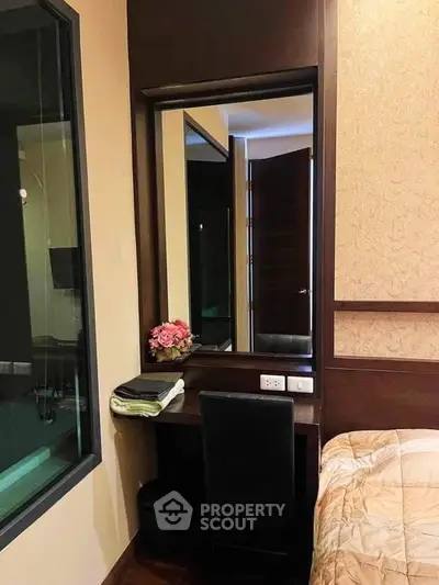 Cozy bedroom corner with elegant vanity and plush bedding
