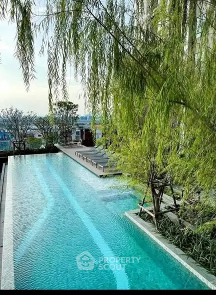 Luxurious outdoor pool with lush greenery and serene ambiance.