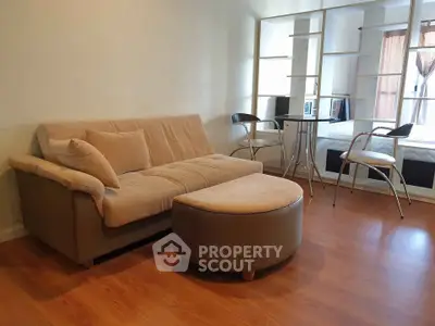 Modern living room with cozy sofa and stylish furniture in open layout apartment.