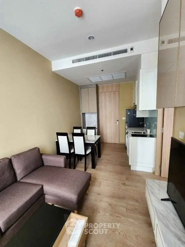 Modern living room with open kitchen layout and stylish furniture