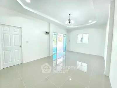 Spacious modern living room with glossy tiled floors and elegant lighting