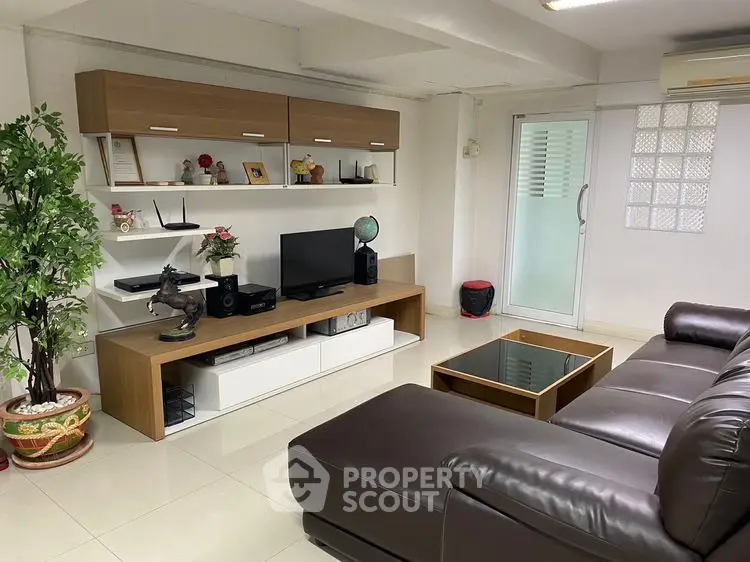 Modern living room with sleek furniture and entertainment center