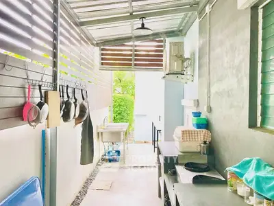 Spacious outdoor kitchen with modern design and ample storage space.