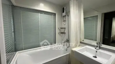 Modern bathroom with bathtub and sleek fixtures in a stylish apartment.