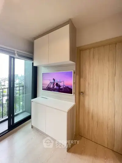 Modern living room with built-in storage and balcony view