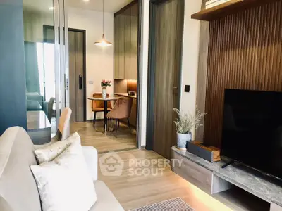 Modern living room with stylish decor and open layout, featuring a cozy seating area and elegant dining space.