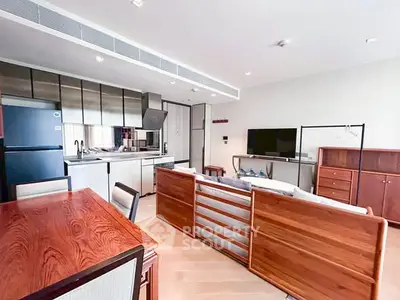 Spacious open-plan living room with modern kitchen and stylish wooden furniture.