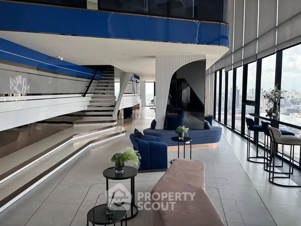 Luxurious modern living room with panoramic city views and stylish furniture.