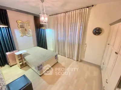 Cozy bedroom with elegant decor and ample natural light