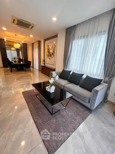 Luxurious living room with elegant decor and spacious dining area, perfect for modern living.